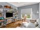 Cozy living room with hardwood floors, a rocking chair, shelving, and comfortable seating at 1324 Cambridge Ave. Sw, Atlanta, GA 30344