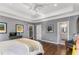 Spacious main bedroom features hardwood floors, large windows, tray ceilings, and ample natural light at 1324 Cambridge Ave. Sw, Atlanta, GA 30344