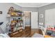 Bright home office with an exercise bike, shelving, and hardwood floors at 1324 Cambridge Ave. Sw, Atlanta, GA 30344