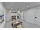Spacious, carpeted basement area featuring a decorative shelving unit and easy kitchen access at 1450 Cedarhurst Dr, Dunwoody, GA 30338