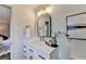 Bright bathroom with a vanity, arched mirror, and modern fixtures at 1450 Cedarhurst Dr, Dunwoody, GA 30338