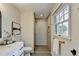 Bright bathroom featuring a modern shower, stylish vanity, and natural light at 1450 Cedarhurst Dr, Dunwoody, GA 30338