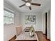 Bright bedroom with wooden floors, ceiling fan, window, and a rustic desk area at 1450 Cedarhurst Dr, Dunwoody, GA 30338