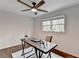 Bright bedroom with wooden floors, ceiling fan, window, and a rustic desk area at 1450 Cedarhurst Dr, Dunwoody, GA 30338