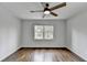 Bedroom featuring hardwood floors, ceiling fan, and natural light from the window at 1450 Cedarhurst Dr, Dunwoody, GA 30338