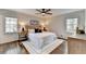 Bright and airy bedroom featuring hardwood floors, dual windows, and neutral décor at 1450 Cedarhurst Dr, Dunwoody, GA 30338