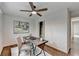 Bright bedroom with wooden floors, ceiling fan, window, and a rustic desk area at 1450 Cedarhurst Dr, Dunwoody, GA 30338