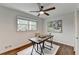 Bright bedroom with wooden floors, ceiling fan, window, and a rustic desk area at 1450 Cedarhurst Dr, Dunwoody, GA 30338