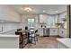 Breakfast nook with wood floors, table and chairs, and natural light from the kitchen at 1450 Cedarhurst Dr, Dunwoody, GA 30338
