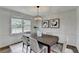 Well-lit dining room featuring a modern chandelier, neutral decor, and seating for six at 1450 Cedarhurst Dr, Dunwoody, GA 30338