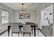 Charming dining room featuring modern light fixture, decor and neutral color palette at 1450 Cedarhurst Dr, Dunwoody, GA 30338