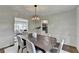 Formal dining room with modern lighting fixture and a large table perfect for entertaining at 1450 Cedarhurst Dr, Dunwoody, GA 30338