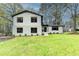 Beautifully renovated two-story home with a freshly painted white brick and siding exterior and manicured lawn at 1450 Cedarhurst Dr, Dunwoody, GA 30338