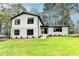 Charming two-story home featuring white painted brick and siding, and a well-maintained front yard at 1450 Cedarhurst Dr, Dunwoody, GA 30338