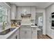 Modern kitchen featuring stainless steel appliances, white cabinets, and quartz countertops at 1450 Cedarhurst Dr, Dunwoody, GA 30338