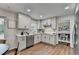 Open kitchen and dining area with modern white cabinetry and stainless steel appliances at 1450 Cedarhurst Dr, Dunwoody, GA 30338