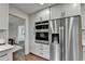 Stainless steel refrigerator and double ovens are surrounded by white cabinets in this home's kitchen at 1450 Cedarhurst Dr, Dunwoody, GA 30338