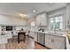 Bright, modern kitchen with white cabinets, stainless steel appliances, and adjacent breakfast area at 1450 Cedarhurst Dr, Dunwoody, GA 30338