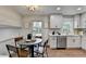 Bright, modern kitchen and breakfast nook with white cabinets and wood floors at 1450 Cedarhurst Dr, Dunwoody, GA 30338