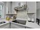 Modern kitchen featuring stainless steel appliances, quartz countertop and mosaic tile backsplash at 1450 Cedarhurst Dr, Dunwoody, GA 30338