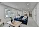 Bright living room featuring neutral colors and an open view to the kitchen and stairs at 1450 Cedarhurst Dr, Dunwoody, GA 30338