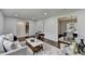 Open living room shows dining area and stairs, with stylish decor and neutral tones, offering a welcoming space at 1450 Cedarhurst Dr, Dunwoody, GA 30338
