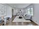 Spacious living room filled with natural light and tasteful decor, including seating and a decorative rug at 1450 Cedarhurst Dr, Dunwoody, GA 30338