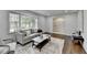Open-concept living room boasts hardwood floors, a large window, and seamless transition to the foyer at 1450 Cedarhurst Dr, Dunwoody, GA 30338