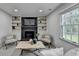 Cozy living room features a fireplace, built-in shelving, and a comfortable blue sofa at 1450 Cedarhurst Dr, Dunwoody, GA 30338
