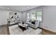Cozy living room features large window, stylish furnishings, plush rug, and modern decor, creating inviting space at 1450 Cedarhurst Dr, Dunwoody, GA 30338