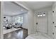 Inviting view of living room and foyer with white doors, contrasted by wood flooring and stylish decor at 1450 Cedarhurst Dr, Dunwoody, GA 30338