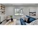 Cozy living room features a fireplace, built-in shelving, and a comfortable blue sofa at 1450 Cedarhurst Dr, Dunwoody, GA 30338