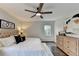 Comfortable main bedroom boasts hardwood flooring, a ceiling fan, and natural light at 1450 Cedarhurst Dr, Dunwoody, GA 30338