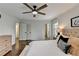 Bright main bedroom featuring an ensuite bathroom, hardwood flooring, and fan at 1450 Cedarhurst Dr, Dunwoody, GA 30338