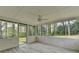 Screened patio with wood-look floors, a ceiling fan, and backyard views at 1450 Cedarhurst Dr, Dunwoody, GA 30338