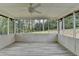 Relaxing screened porch with plank flooring, ceiling fan, and view of the green backyard at 1450 Cedarhurst Dr, Dunwoody, GA 30338