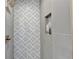 Modern stand-up shower featuring stylish tile design, gold accents, and functional niche at 1450 Cedarhurst Dr, Dunwoody, GA 30338