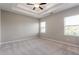 Spacious bedroom with tray ceiling, carpeted floor and bright windows at 4589 Hawthorn Rose Ln, Buford, GA 30518