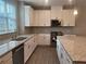 Well-lit kitchen with granite countertops, stainless steel appliances, and ample cabinetry at 4589 Hawthorn Rose Ln, Buford, GA 30518