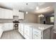 Open kitchen with a large island, granite countertops, stainless steel appliances and pendant lighting at 4589 Hawthorn Rose Ln, Buford, GA 30518