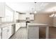 Modern kitchen with white cabinets, stainless appliances, and a large center island at 4589 Hawthorn Rose Ln, Buford, GA 30518
