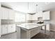 Spacious kitchen featuring white cabinets, granite countertops, and a functional center island at 4589 Hawthorn Rose Ln, Buford, GA 30518