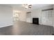 Open living room with fireplace and built-in shelving, seamlessly connected to the kitchen at 4589 Hawthorn Rose Ln, Buford, GA 30518