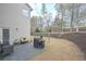 View of the backyard with a patio, grill, and well-maintained lawn in a desirable neighborhood at 5111 Olive Branch Cir, Powder Springs, GA 30127
