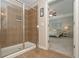 Tiled walk-in shower with glass doors, leading to primary bedroom at 5111 Olive Branch Cir, Powder Springs, GA 30127