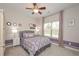 Charming bedroom with a ceiling fan, natural light, and patterned bedding at 5111 Olive Branch Cir, Powder Springs, GA 30127