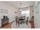 Dining room with hardwood floors, a modern light fixture, and natural lighting at 5111 Olive Branch Cir, Powder Springs, GA 30127