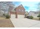 Beautiful brick home featuring a large driveway and well-manicured landscaping, enhancing curb appeal at 5111 Olive Branch Cir, Powder Springs, GA 30127