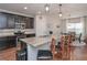 Beautiful kitchen with dark cabinets, stainless steel appliances, granite countertops and seating at island at 5111 Olive Branch Cir, Powder Springs, GA 30127