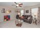 Living room featuring plush furniture, ceiling fan, and decorative art at 5111 Olive Branch Cir, Powder Springs, GA 30127